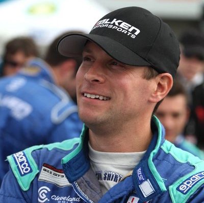 A close up of a person wearing a racing suit
